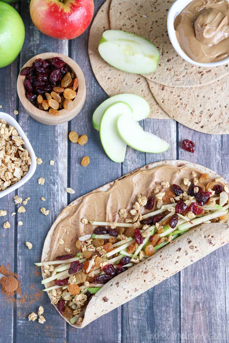 Peanut butter spread onto a wheat tortilla with fruit and granola