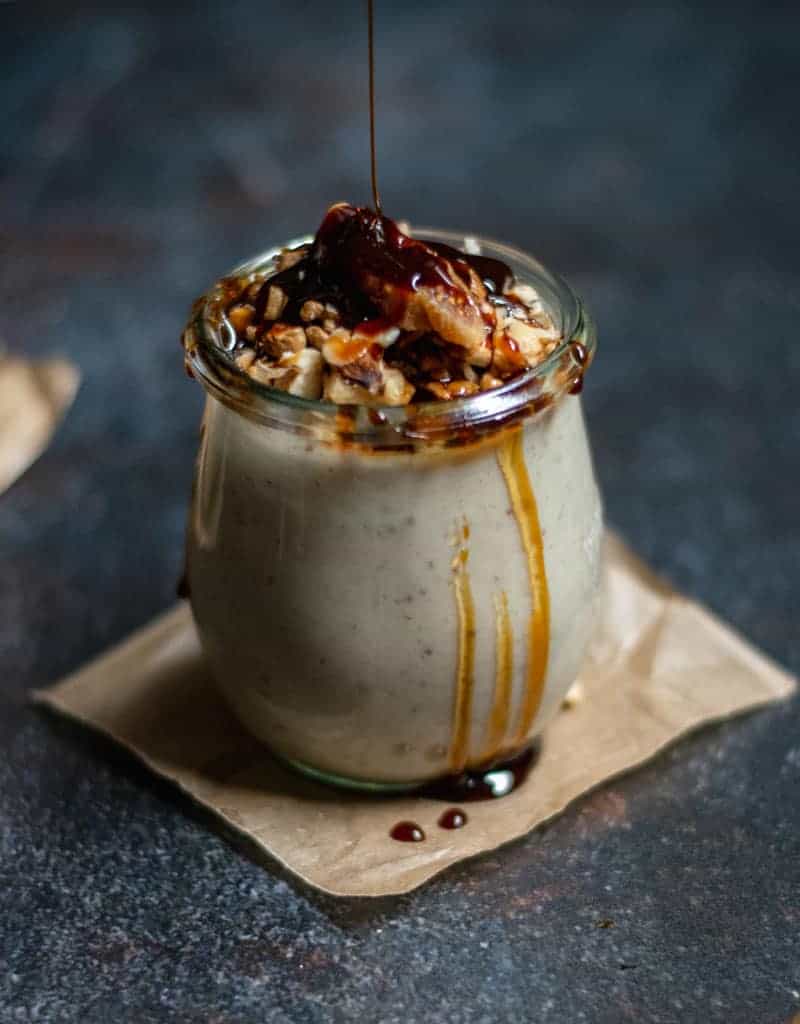 Pudding in a small jar with molasses running down the side