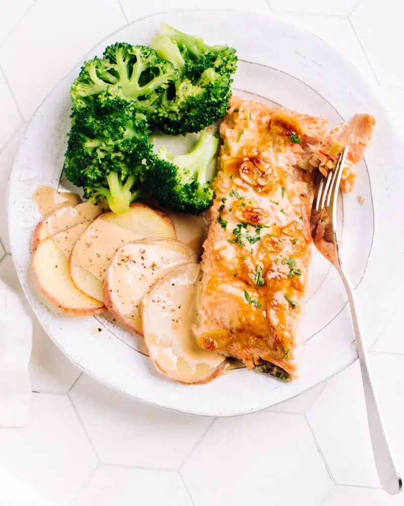 Air-fried salmon on plate next to broccoli