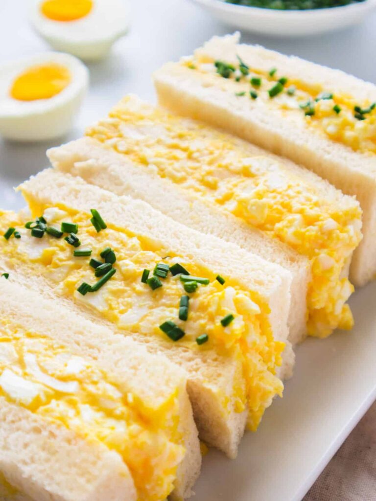 4 Japanese egg salad sandwiches on a cutting board